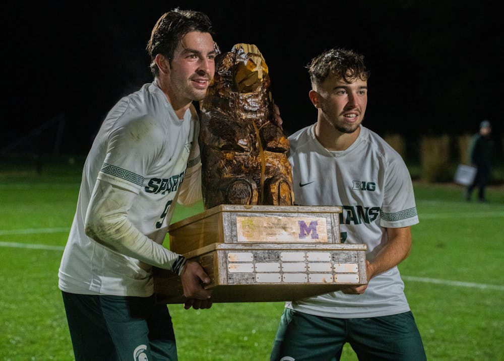 <p>Michigan State junior forward Greyson Mercer (9) and junior midfielder Vedad Kovac (7) pose with the Big Bear trophy at DeMartin Stadium on Sept. 27, 2022. Spartans defeated the Wolverines 2-0. </p>