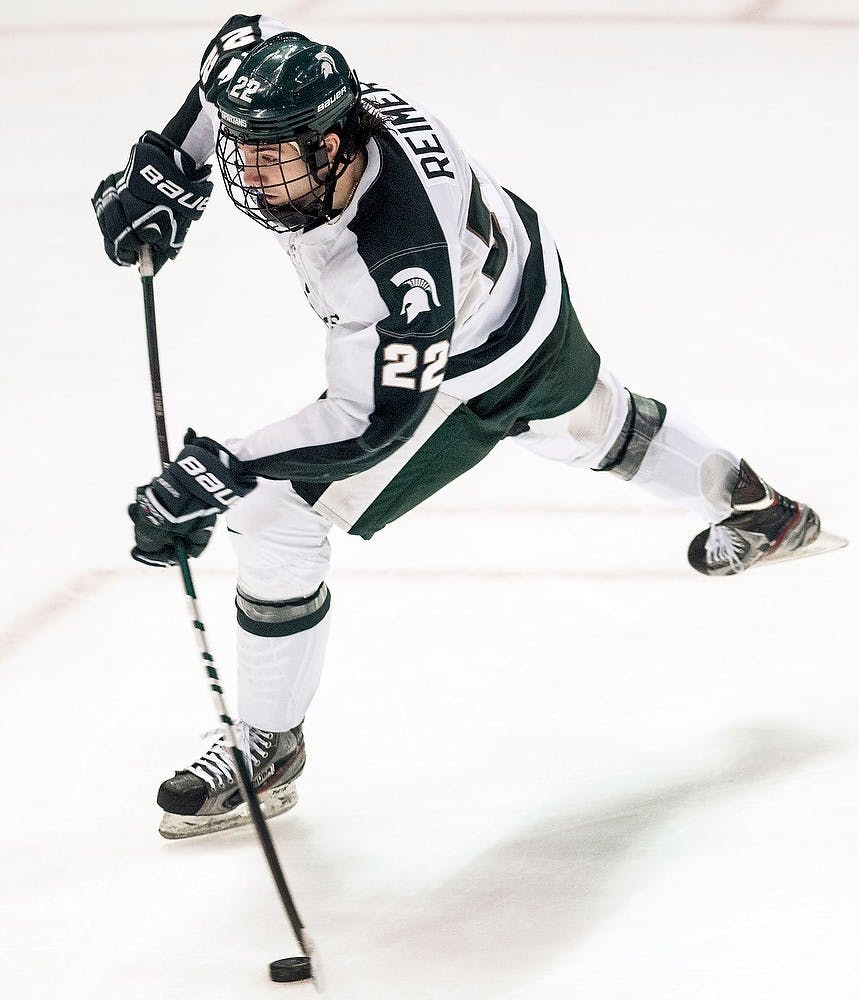 	<p>Junior forward Lee Reimer takes a wrist shot at the Michigan net Saturday, Feb. 2, 2013, at Joe Louis Arena in Detroit. The Wolverines defeated the Spartans, 5-2, in the second game of the weekend series. Adam Toolin/The State News</p>