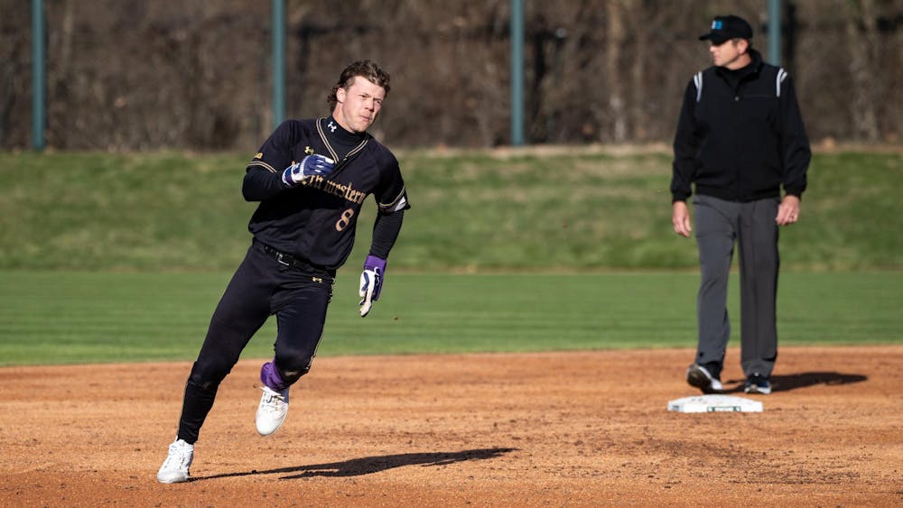 Northwestern junior infielder Owen McElfatrick (8) completes 3 bases after a sucessful swing at MSU Jeff Ishiba Field on April 11, 2025.