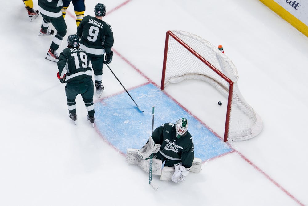 <p>Spartans lazily walk-skate away from the goal after the University of Michigan scored during the second period of the Duel in the D at Little Caesars Arena on Feb. 11, 2023. The Spartans fell to the Wolverines with a score of 4-3.</p>