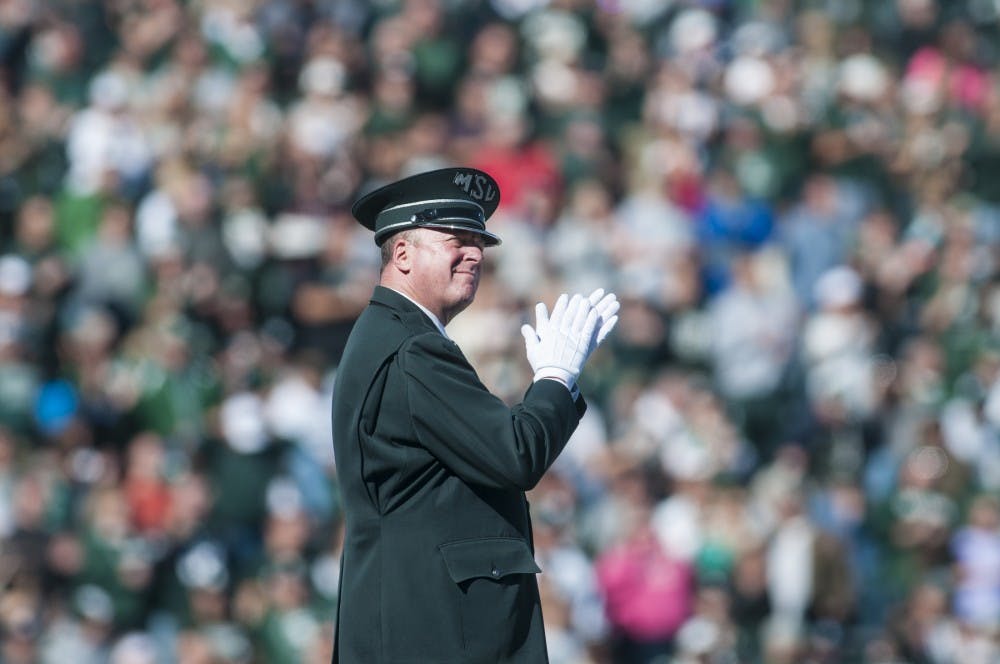 Marching band director John T. Madden directs the band through the MSU fight song before the game against Brigham Young University on Oct. 8, 2016 at Spartan Stadium.  The Spartans were defeated by the Cougars, 31-14. 