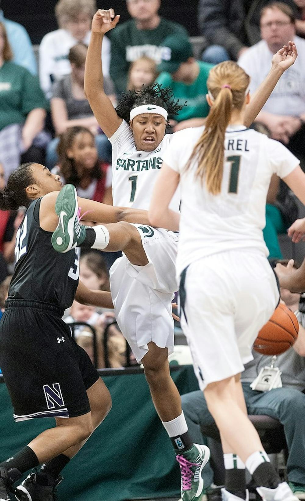 	<p>Senior guard Jasmine Thomas jumps to try to block a shot from Northwestern guard La&#8217;Terria Taylor during the game Feb. 20, 2013, at Breslin Center. <span class="caps">MSU</span> beat Northwestern, 54-45, of which Thomas scored 10 points. Danyelle Morrow/The State News</p>
