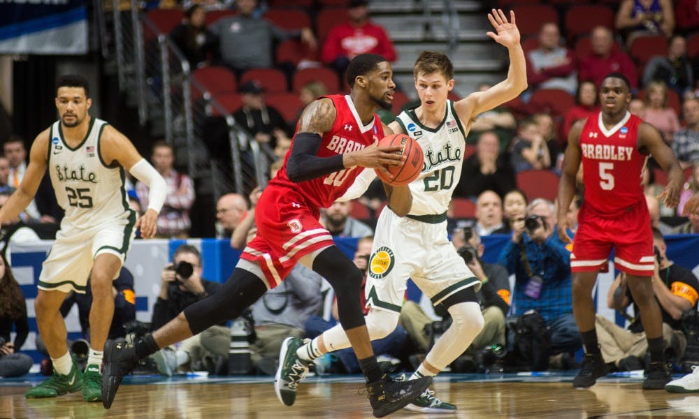 Senior forward Matt McQuaid (20) guards Bradley forward Elijah Childs (10) during the NCAA tournament game against Bradley at Wells Fargo Arena March 21, 2019. The Spartans defeated the Braves, 76-65.