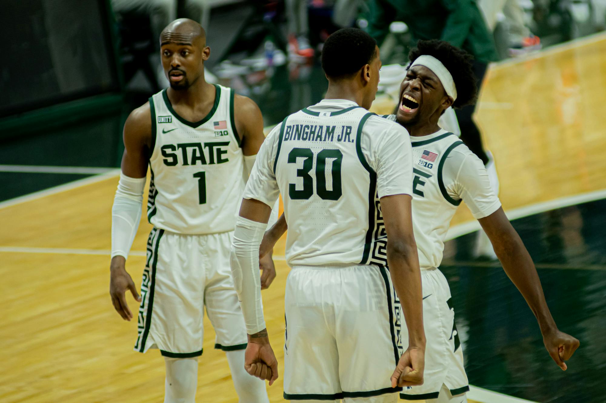 <p>Juniors Gabe Brown and Marcus Bingham Jr. celebrate a Bingham dunk and and-one opportunity against Illinois on Feb. 23, 2021. The Spartans beat the Fighting Illini, who were second in the conference, 81-72.</p>