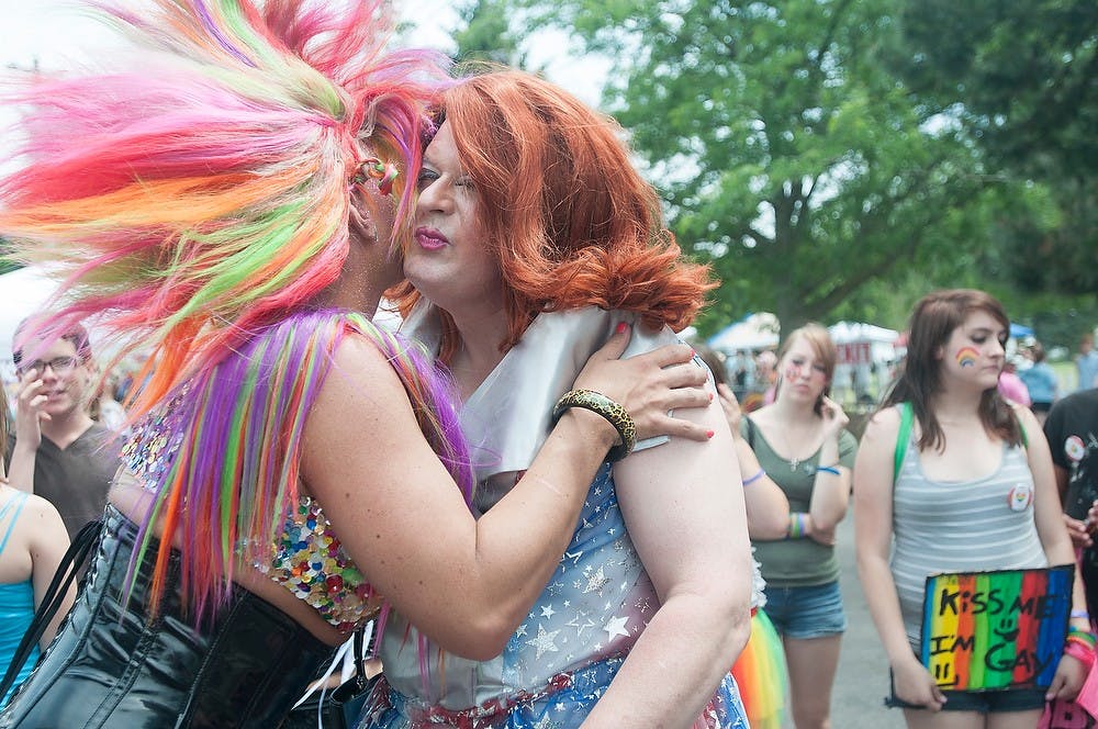 	<p>Lansing residents Ace DeVille, left, and Paige Turner say hello to each other in Old Town at the 23rd Annual Michigan Pride Festival Saturday afternoon, June 16, 2012. The festival included an array of vendor booths, face painting and musical performances among others. State News File Photo</p>