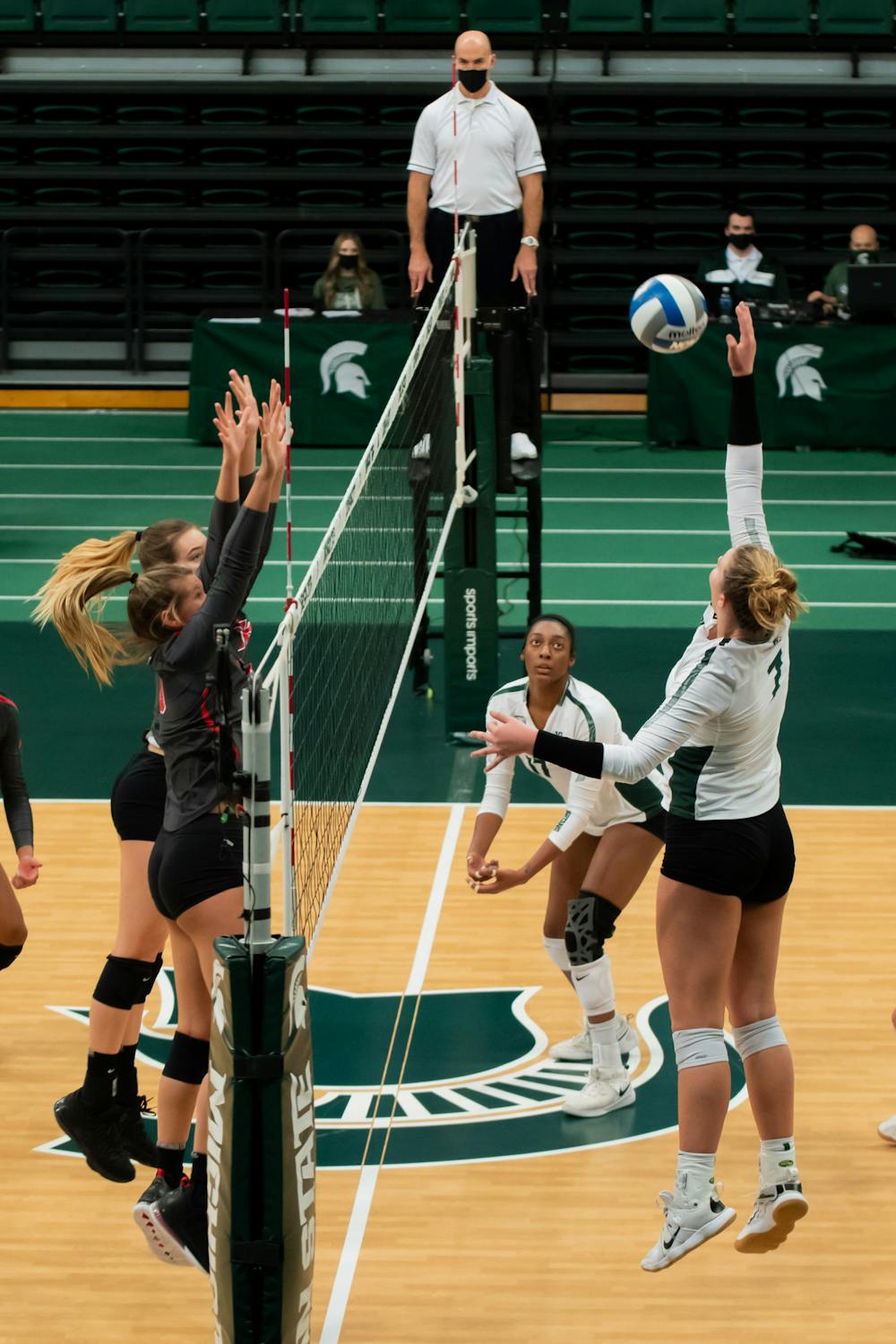 <p>Freshman outside hitter Sarah Franklin attempts to spike the ball over two pairs of Ohio State hands during the Spartans&#x27; 3-0 loss to Ohio State on Jan. 31, 2021.</p>