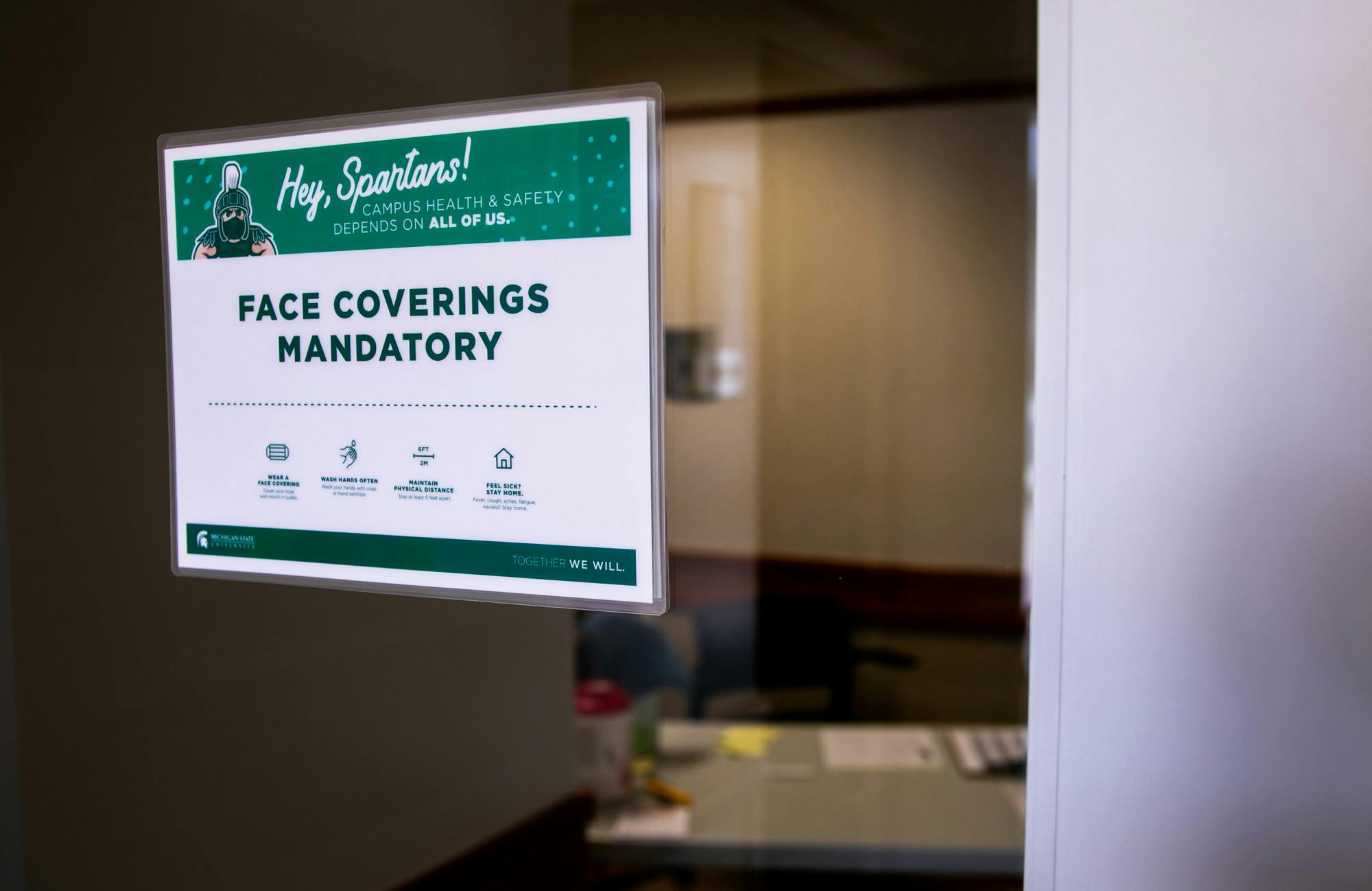 <p>A sign requiring face coverings posted outside Olin Health Center on Aug. 24, 2020.</p>