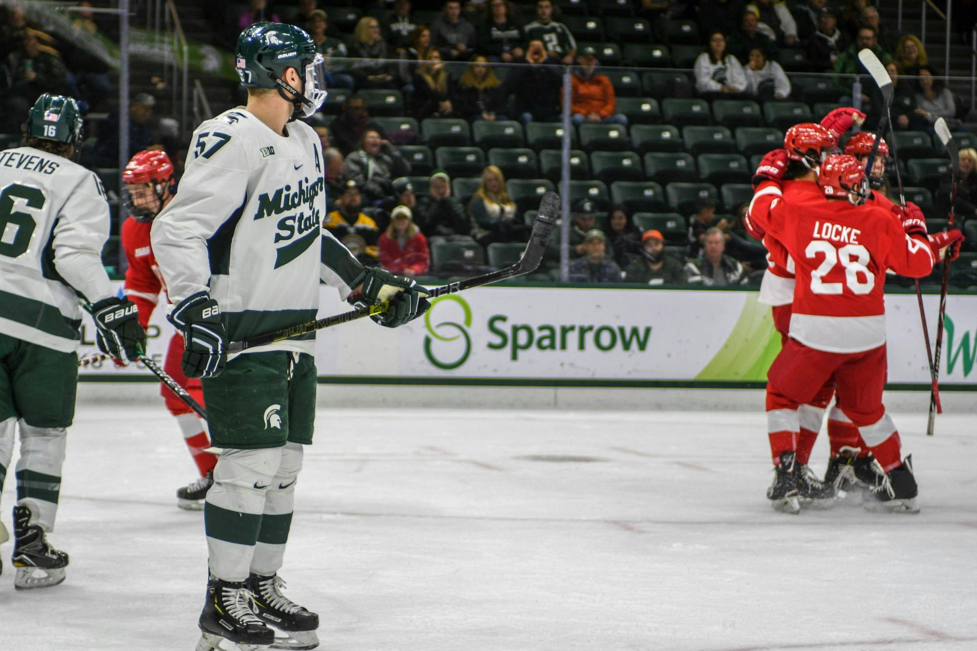 <p>Redshirt senior left defense Jerad Rosburg (57) watches as Cornell players celebrate a goal during the game against Cornell at Munn Ice Arena on Nov. 1, 2019. The Spartans fell to the Big Red, 3-2.</p>