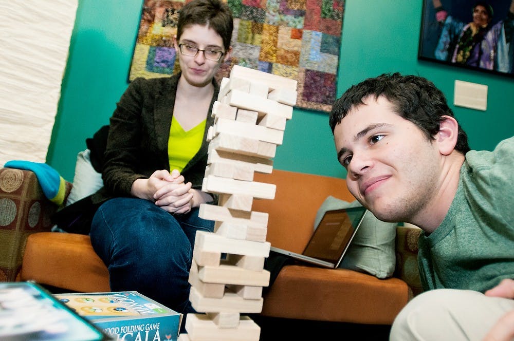 	<p>Media and information junior Elliot Zirulnik, right,  concentrates while playing &#8220;Tumbling Towers&#8221; against journalism junior Monica Reida at the <span class="caps">LGBT</span> Resource Center Spring Open House on Monday, Jan. 14, 2013 at the Student Services building. The open house gave students a chance to gather information about the program, ask questions and meet new people. Katie Stiefel/ The State News</p>