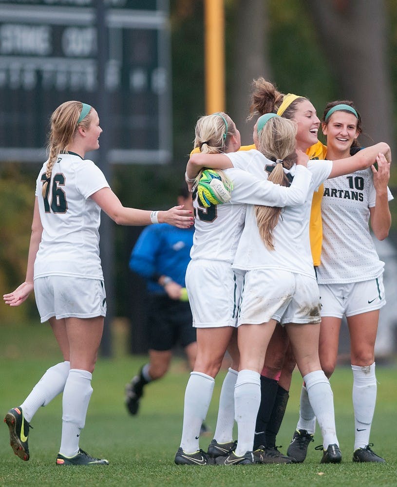 <p>The Spartans celebrate after a win against Ohio State on Oct. 16, 2014, at the DeMartin Soccer Stadium at Old College Field. The Spartans defeated the Buckeyes, 2-1. Jessalyn Tamez/The State News </p>