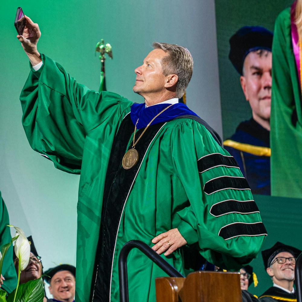 <p>Michigan State University's president, Kevin Guskiewicz, takes a selfie with the graduating class during a convocation inside the Breslin Center in East Lansing, Mich., on May 1, 2026.</p>