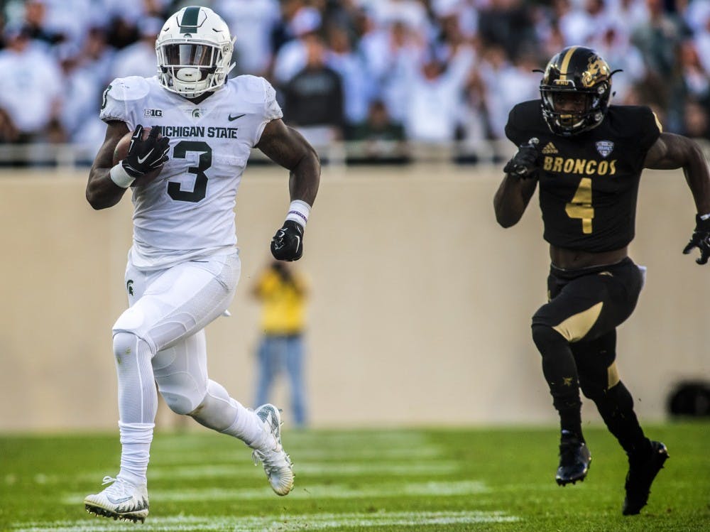 Junior running back L.J. Scott (3) runs the ball during the game against Western Michigan on Sept. 9, 2017 at Spartan Stadium. The Spartans defeated the Broncos, 28-14.