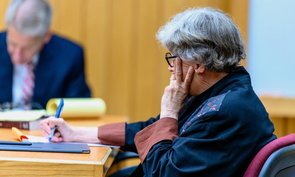 Former MSU President Lou Anna K. Simon takes notes during the continuation of her preliminary exam at the Eaton County Courthouse on July 12, 2019. 