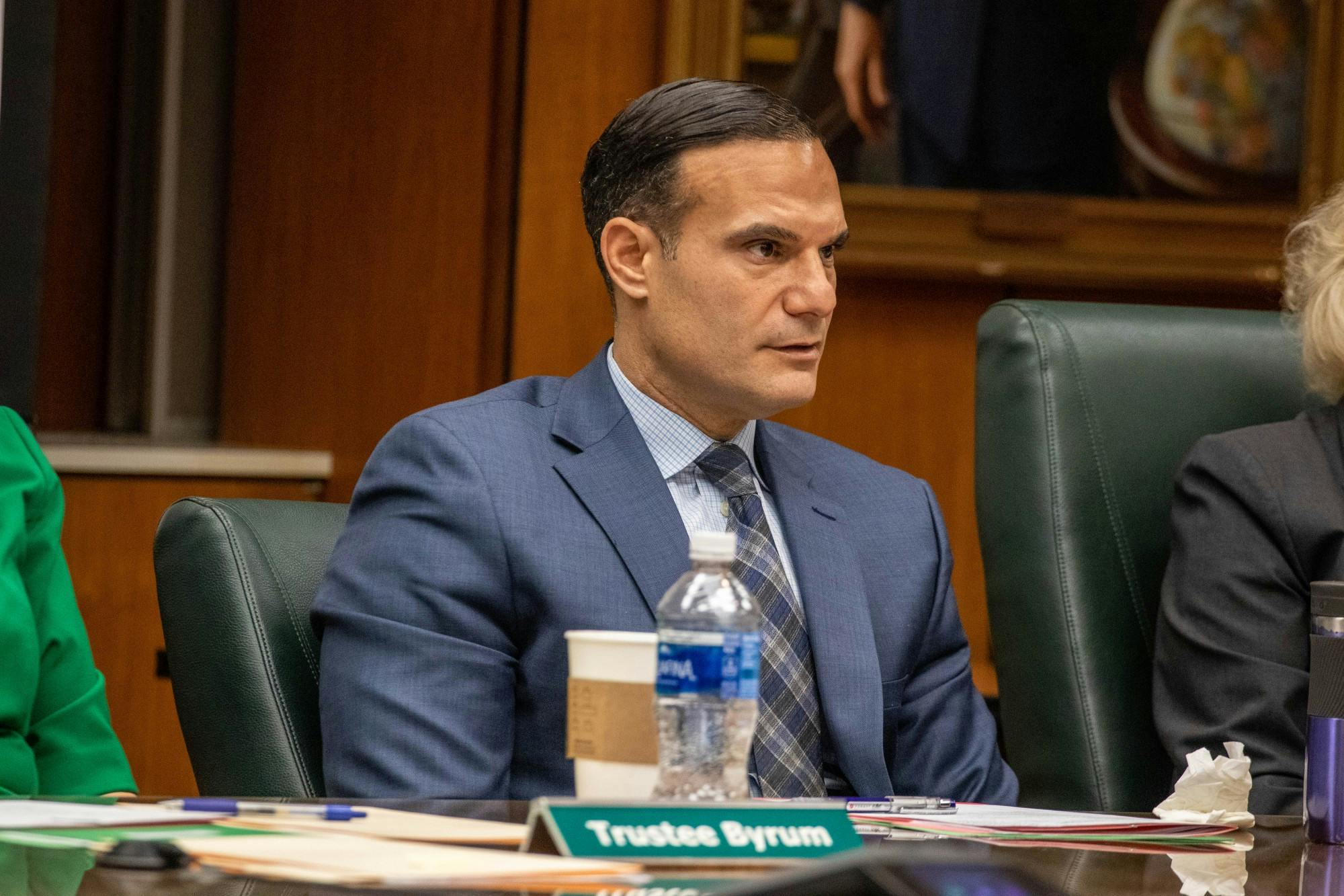 <p>Trustee Brian Mosallam listens at the Board of Trustees meeting on Dec. 13, 2019.</p>