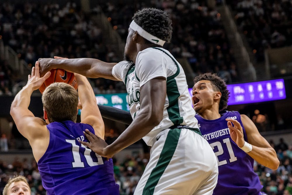 <p>Then-sophomore forward Gabe Brown (center) battles with Northwestern’s Miller Kopp (left) and A.J. Turner (right) for a rebound. The Spartans defeated the Wildcats, 79-50, at the Breslin Student Events Center on Jan. 29, 2020. </p>