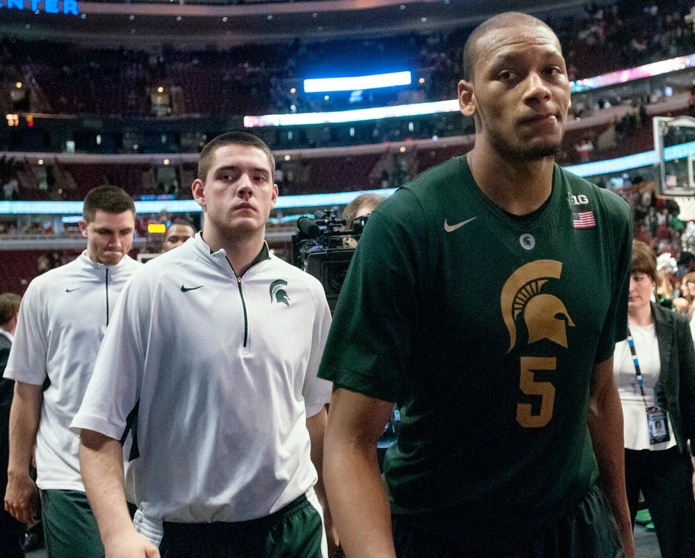 	<p>Junior forward Adreian Payne, right, freshman forward Kenny Kaminski, center, and sophomore forward Alex Gauna, left, walk off the court after the conclusion of  the semifinal round of the Big Ten Tournament on March 16, 2013, at United Center in Chicago, Ill. The Buckeyes beat the Spartans 61-58. Natalie Kolb/The State News</p>