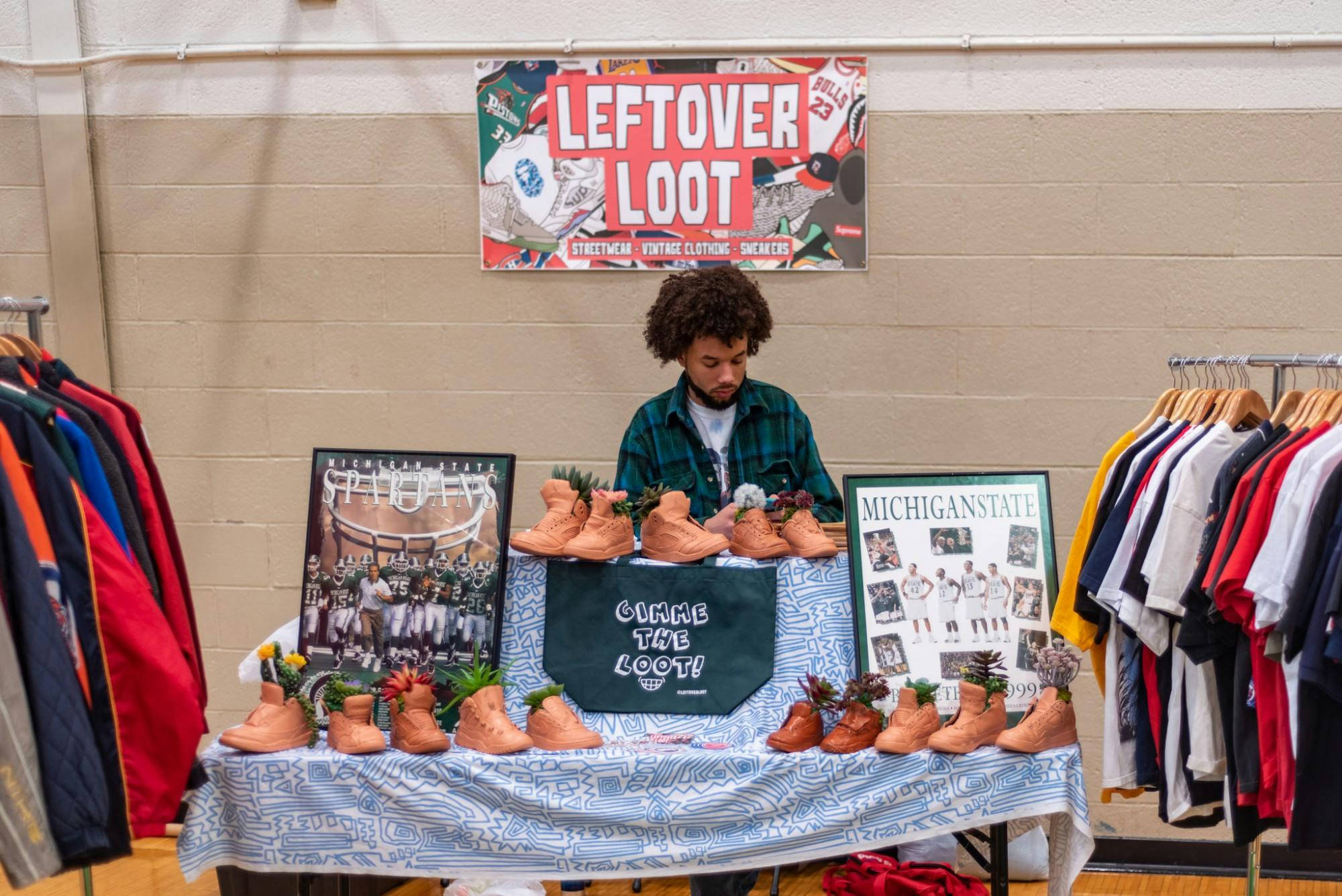 <p>A seller waits at his booth, decorated with sneaker-shaped plant pots at the Sparta-Kickz convention at IM Sports West on Feb. 23, 2020. </p>