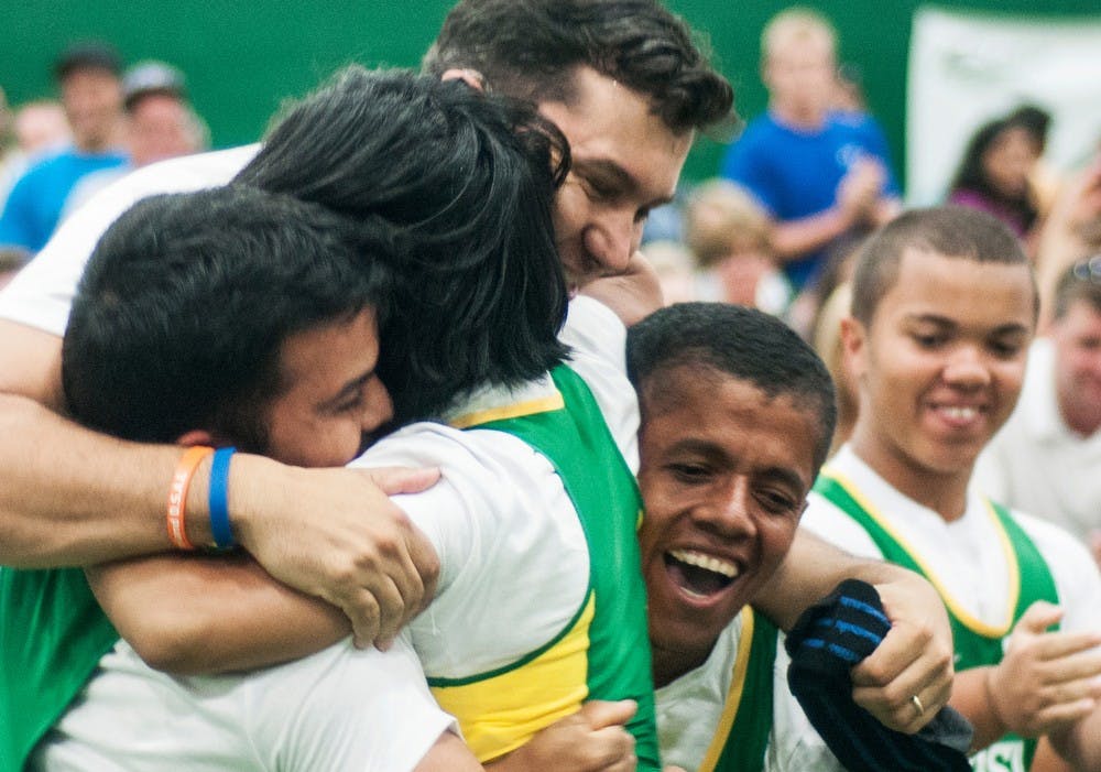 	<p>The Brazilian weight lifters celebrate with one of the coaches after a successful lift by one of the team members at the 2013 World Dwarf Games, August 9, 2013, in the Tennis Courts of IM West. Brazil brought four competitors to the competition. Danyelle Morrow/The State News</p>