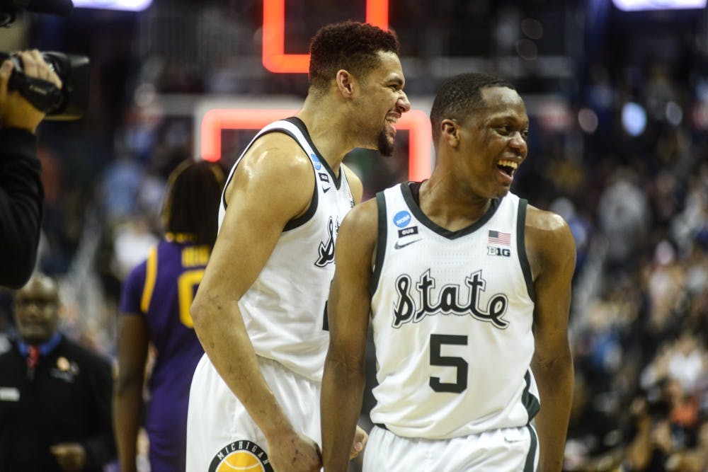 Junior guard Cassius Winston (5) and Redshirt senior Kenny Goins (25) celebrate during the game against LSU at Capital One Arena on March 29, 2019. The Spartans defeated the Tigers, 80-63.
