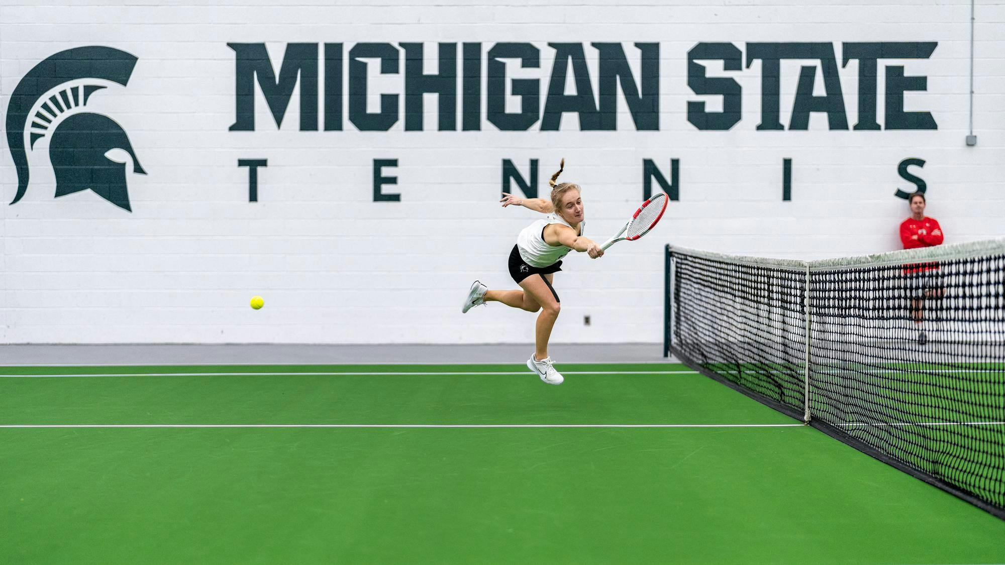 <p>Michigan State senior Liisa Vehviläinen misses a serve in a match against Ohio State at the MSU Tennis Center in Lansing, Michigan on Mar. 16, 2025. The Buckeyes won 4-0 and are 23-2 overall against the Spartans since the first time they met in 2001.</p>