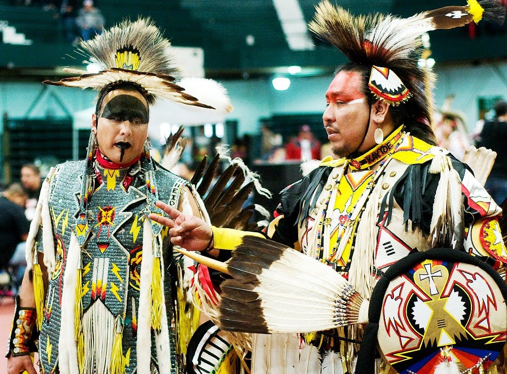Lawton, N.Y. resident Charles Belisle and Milwaukee, Wisc. resident Kelly Kaytoe Logan talk as the music ends Feb. 18, 2012, at Jension Fieldhouse. Belisle and Logan were both attending the 29th annual Pow Wow of Love. State News File Photo
