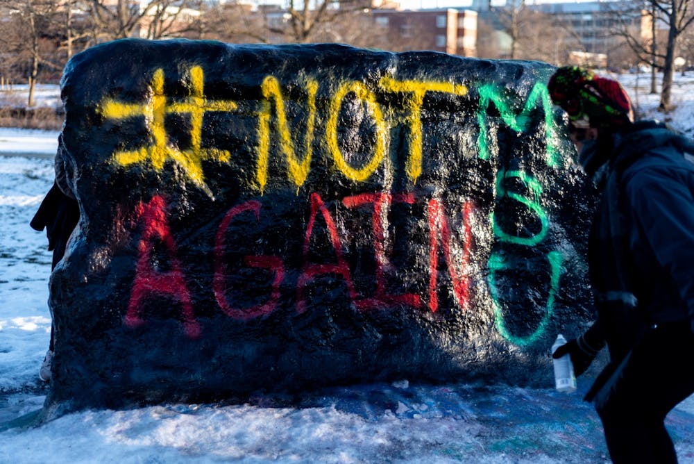 Members of MSU’s Black Student Alliance paint the Rock on Farm Lane as a part of their Black Revolt Week on February 19, 2020. 