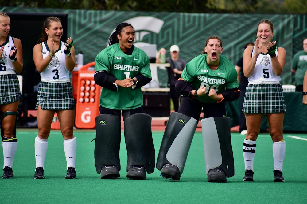 <p>Michigan State women's field hockey sophomore goalkeeper Cecily Chambers, #00, hypes up the crowd before a game against Ohio State at Ralph Young Field on Sept. 17, 2023. The Spartans lost 2-1 in overtime.</p>