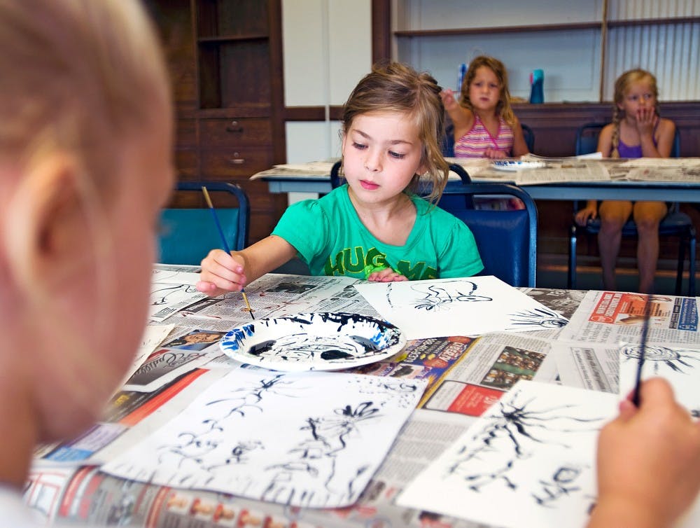 	<p>Six-year-old Maddie Polleys, center, of East Lansing participates in one of many week-long art camps this summer at East Lansing Hannah Community Center, 819 Abbot Road. Wednesday&#8217;s Art Around the World class learned a Japanese style of painting called Sumi-e</p>