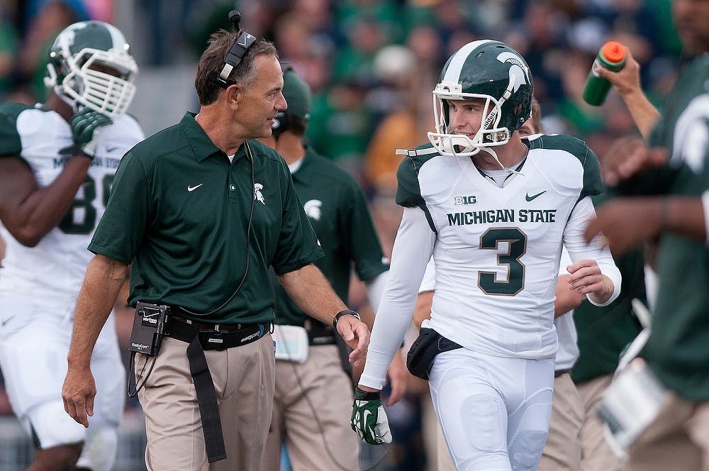 <p>Head coach Mark Dantonio talks to junior punter Mike Sadler during the game against Notre Dame Sept. 21, 2013, at Notre Dame Stadium in South Bend, Ind. The Fighting Irish defeated the Spartans 17-13. Julia Nagy/The State News</p>