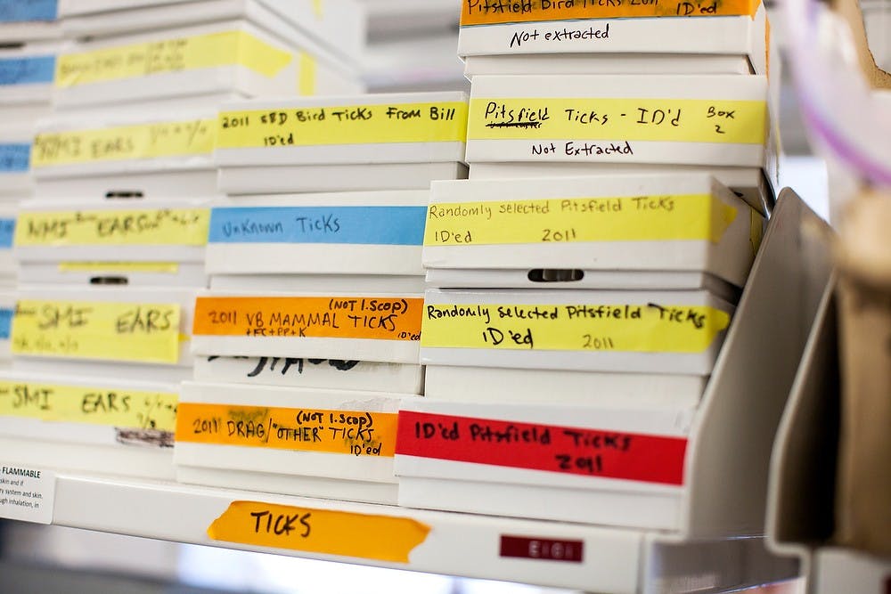 <p>Boxes of tick samples are stacked on a shelf July 3, 2014, at the Biomedical and Physical Sciences Building on campus. Dr. Jean Tsao's team collects the tick samples by systematically dragging cloth across forest foliage. Corey Damocles/The State News </p>