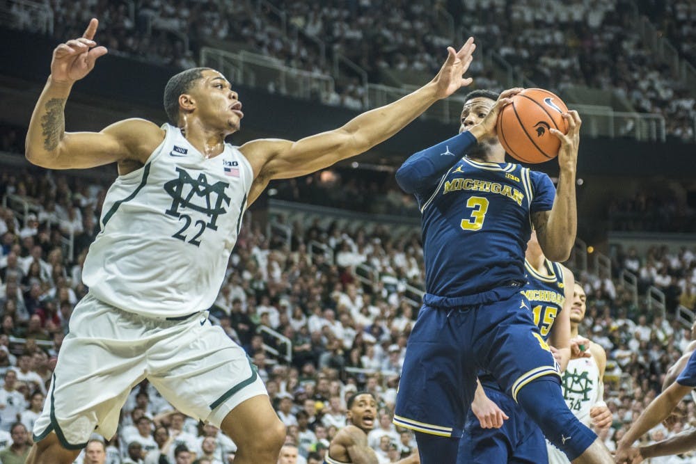 Sophomore guard Miles Bridges (22) covers Michigan guard Zavier Simpson (3) during the men's basketball game against Michigan on Jan. 13, 2018 at Breslin Center. The Spartans were defeated by the Wolverines, 82-72. (Nic Antaya | The State News)