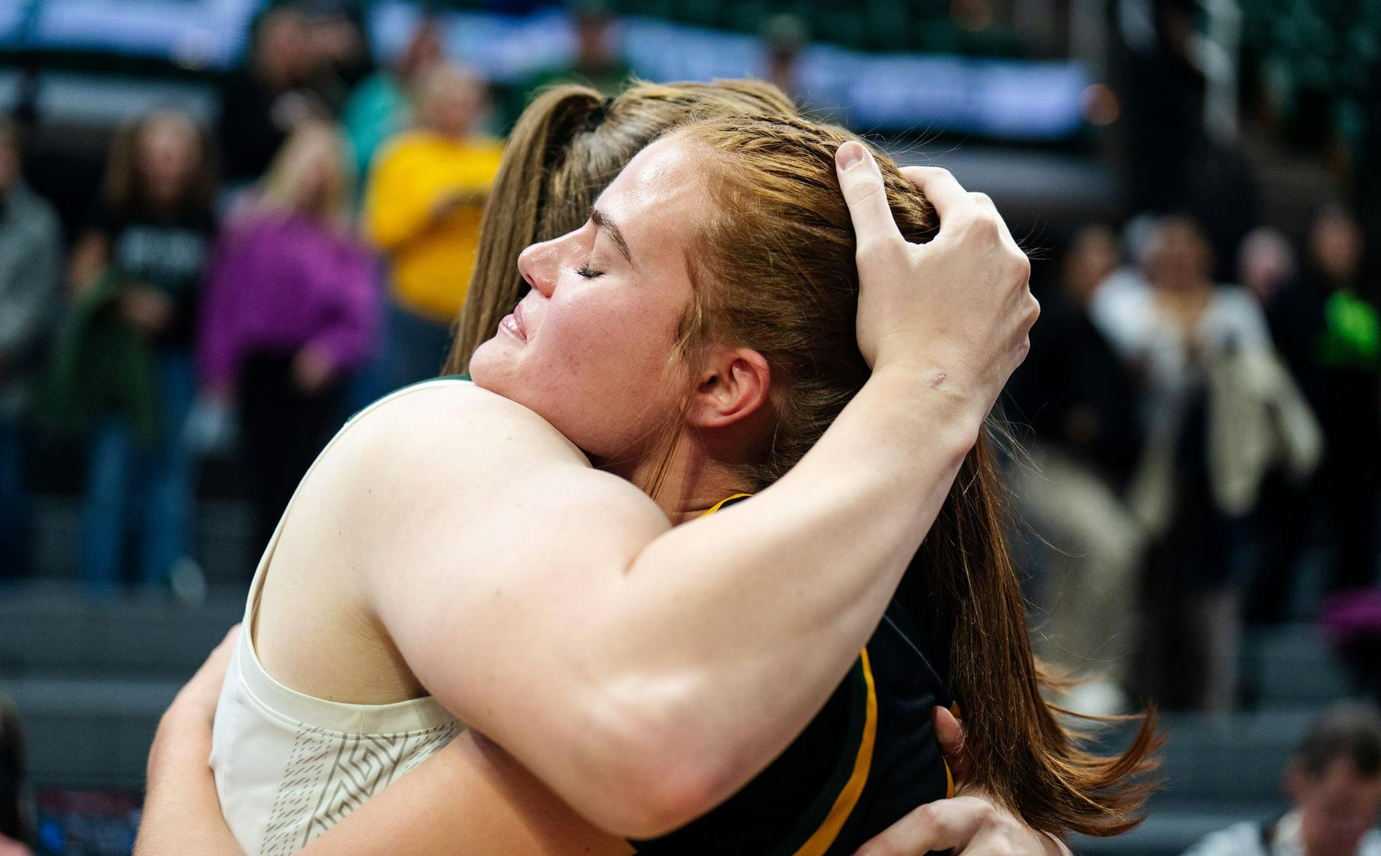 <p>Michigan State University graduate guard Julia Ayrault (40) hugs her sister, Wayne State University sophomore guard Annabel Ayrault (40), after the season-opening exhibition game against Wayne State University at the Breslin Center on Oct. 28, 2024. Ayrault competed against her sister Annabel on the WSU team where their father, Andy Ayrault, serves as the assistant coach.</p>