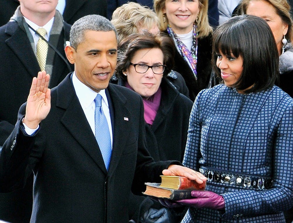 	<p>President Barack Obama is sworn-in for a second term as the President of the United States as Michelle Obama holds the bible during his public inauguration ceremony at the U.S. Capitol in Washington, D.C. on Jan. 21, 2013. Michelle Obama holds the bible. Mark Gail/MCT</p>