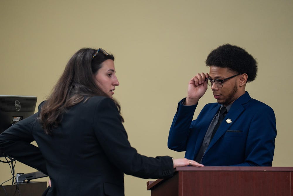 The two ASMSU President candidates, Maddie Hanes (left) and Deonte Sparks (right), talk to each other at the podium after giving their final words to the public in the Student Affairs & Services building in East Lansing, MI on April 14, 2026.