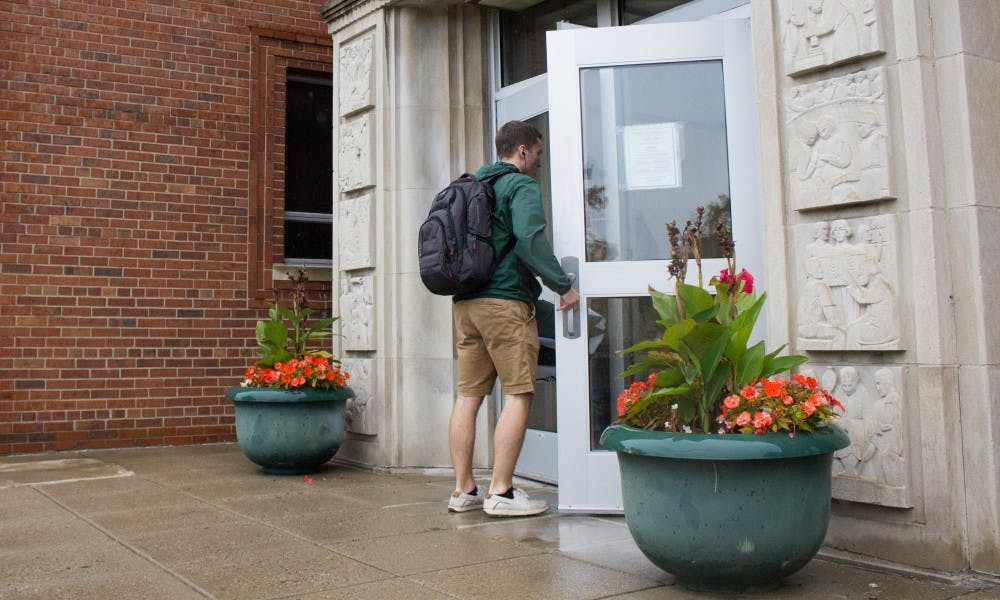 <p>A student walks into Olin Health Center on Oct. 23, 2017.</p>