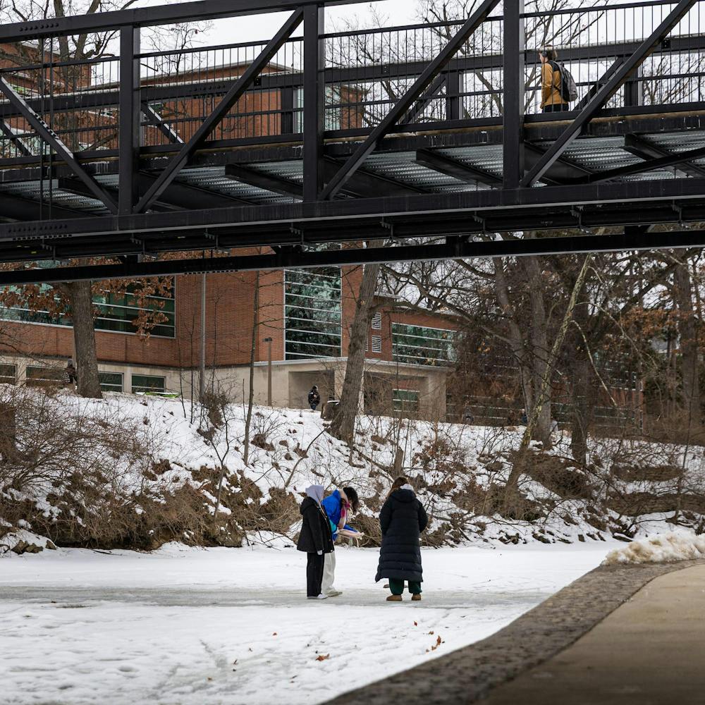 MSU students play on the frozen over Red Cedar River in East Lansing, MI on Feb. 11, 2026.
