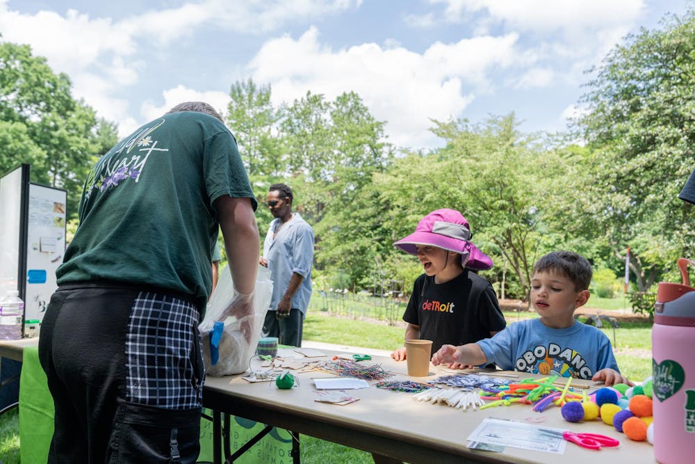 <p>Young attendees of the Music and the Garden event build insects out of art supplies in East Lansing, Mich., on June 28, 2026.</p>