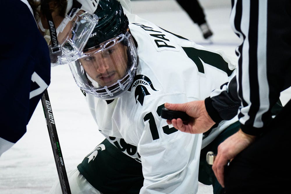 <p>Sophomore forward Kristof Papp (13) focuses on the puck at Munn Ice Arena on Feb. 25, 2022. The Spartans fell to the Nittany Lions with a score of 5-3.</p>