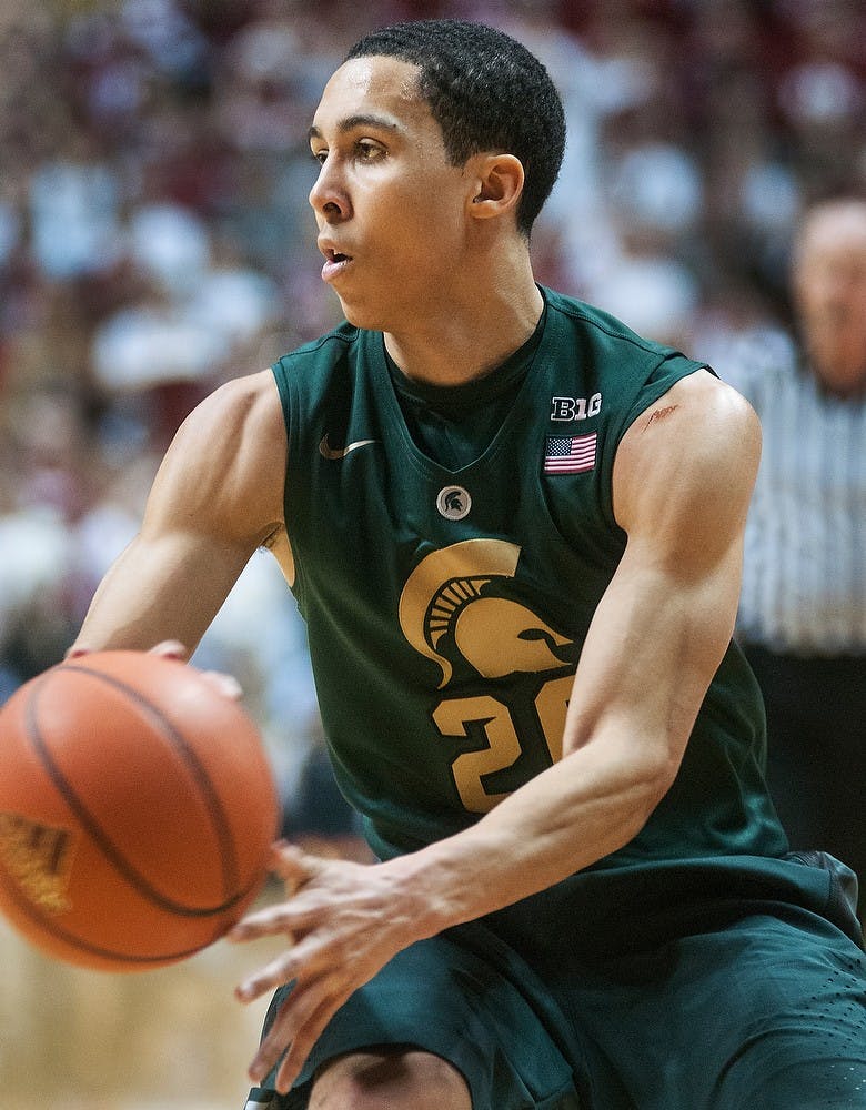 	<p>Sophomore guard Travis Trice throws a no-look pass Sunday, Jan. 27, 2013, at Assembly Hall in Bloomington, Ind. Indiana defeated the Spartans, 75-70, giving <span class="caps">MSU</span> its second loss in the Big Ten. Adam Toolin/The State News</p>