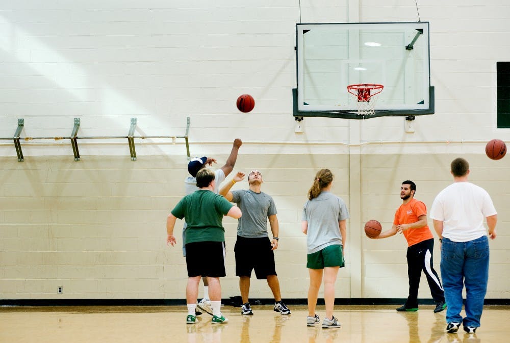 Students practice basketball on Tuesday afternoon at IM-Sports West. The IM Sports facilities have postponed a plan to consolidate fitness fee into next year's on-campus housing fee. Justin Wan.The State News