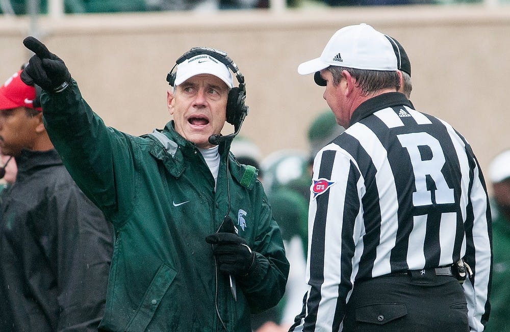 	<p>Head coach Mark Dantonio talks with referees during a game against Iowa on Saturday, Oct. 13, 2012 at Spartan Stadium. The teams headed into overtime tied, but the Spartans lost, 19-16. Julia Nagy/The State News</p>