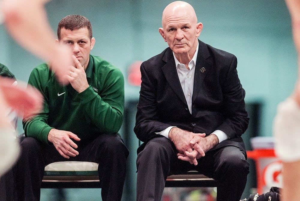 	<p>Head coach Tom Minkel, right, watches the match with assistant head coach Roger Chandler on Feb. 22, 2013, at Jenison Field House.  Central Michigan defeated <span class="caps">MSU</span> 27-10. Adam Toolin/The State News</p>