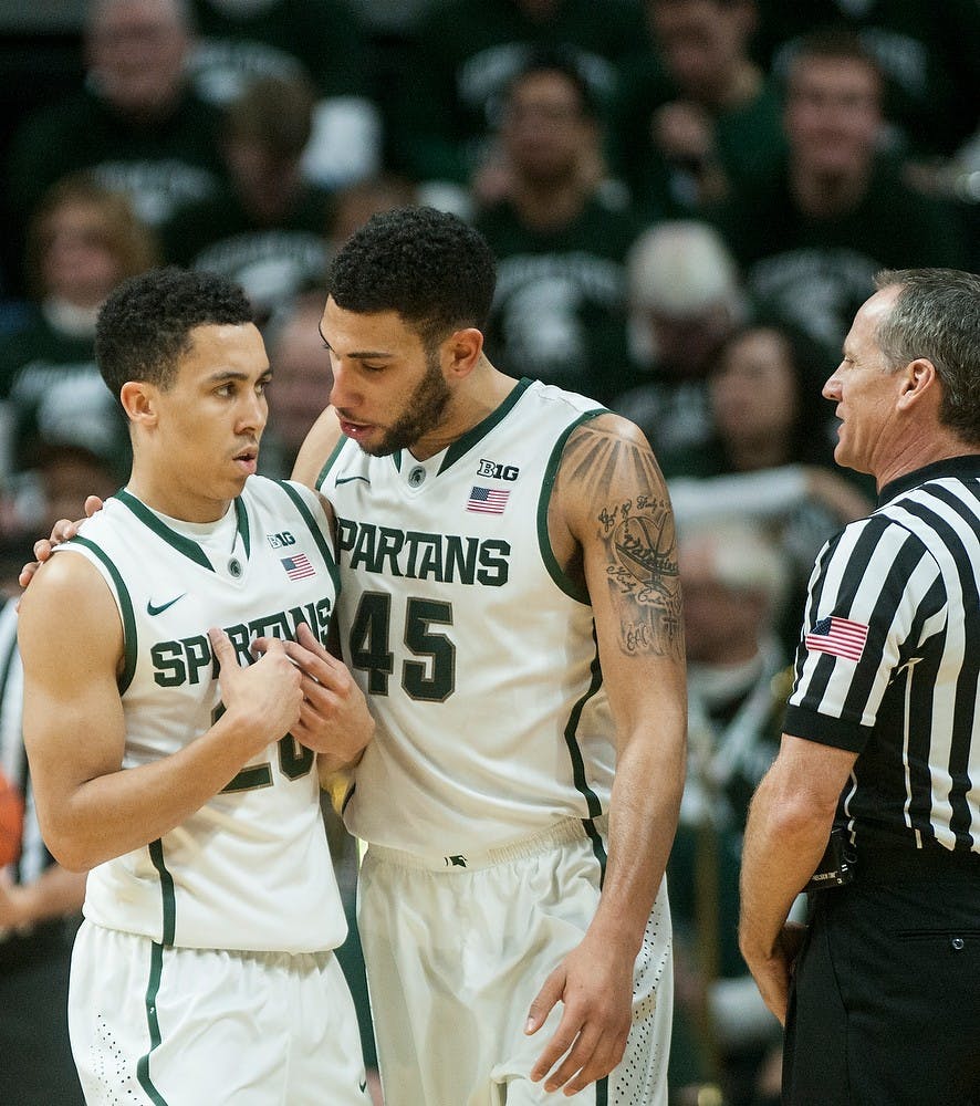 <p>Junior guard Denzel valentine comforts senior guard Travis Trice after a foul is called on him Jan. 5, 2015, during the game against Indiana at Breslin Center. The Spartans defeated the Hoosiers, 70-50. Erin Hampton/The State News</p>