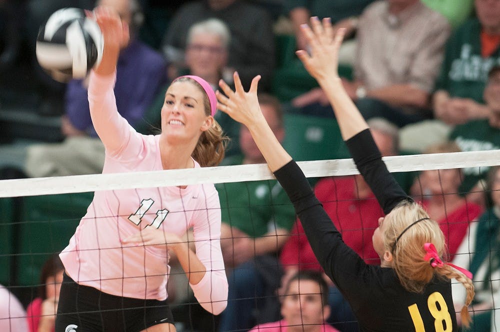 	<p>Freshman outside hitter Chloe Reinig hits the ball while University of Iowa middle blocker/outside hitter Lauren Brobst tries to block, Oct 11, 2013, at Jenison Field House. The Spartans defeated the Hawkeyes, 3-0. Georgina De Moya/The State News</p>