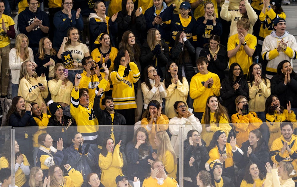 <p>University of Michigan fans cheer after a fan catches the puck at the Yost Ice Arena in Ann Arbor, Mich. on Dec. 6, 2025.</p>
