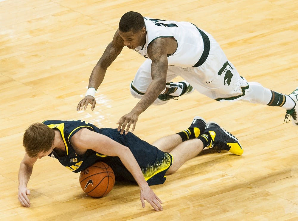 	<p>Senior guard Keith Appling trips over Michigan guard Spike Albrecht on Jan. 25, 2014, at Breslin Center. The Spartans lost to the Wolverines, 80-75. Danyelle Morrow/The State News</p>