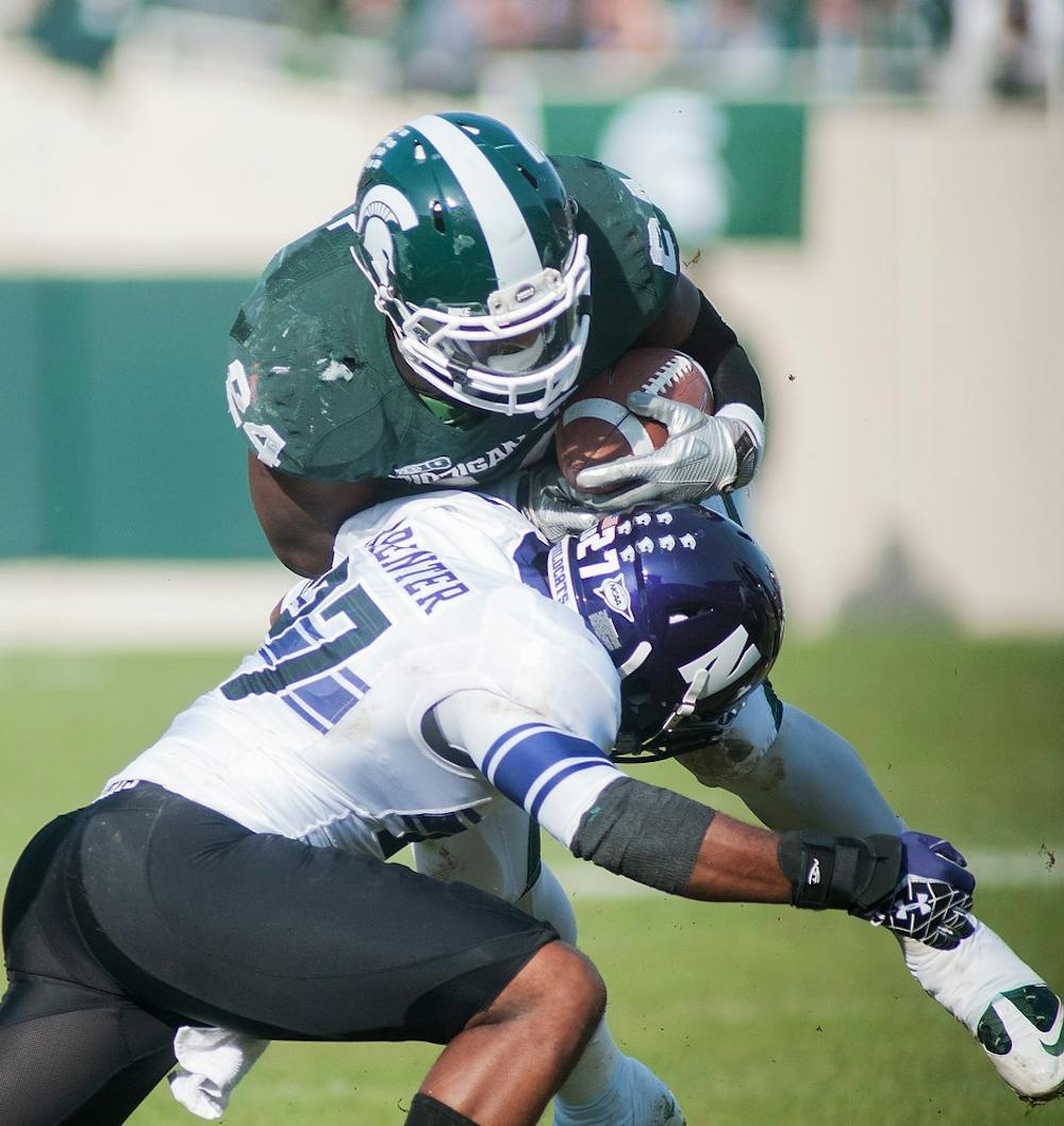 	<p>Junior running back Le&#8217;Veon Bell gets taken down by safety Jared Carpenter on Saturday, Nov. 17, 2012, at Spartan Stadium. Bell finished the game with 133 rushing yards in the Spartans&#8217; 23-20 loss to Northwestern. James Ristau/The State News</p>