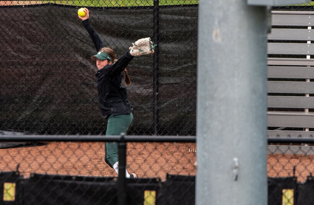 <p>Freshman pitcher Ashley Miller (7) practices pitching along the first base line during the game against Purdue. The Boilermakers made a seven-run comeback in the sixth inning to top the Spartans 9-6 at Secchia Stadium on April 24, 2021.</p>