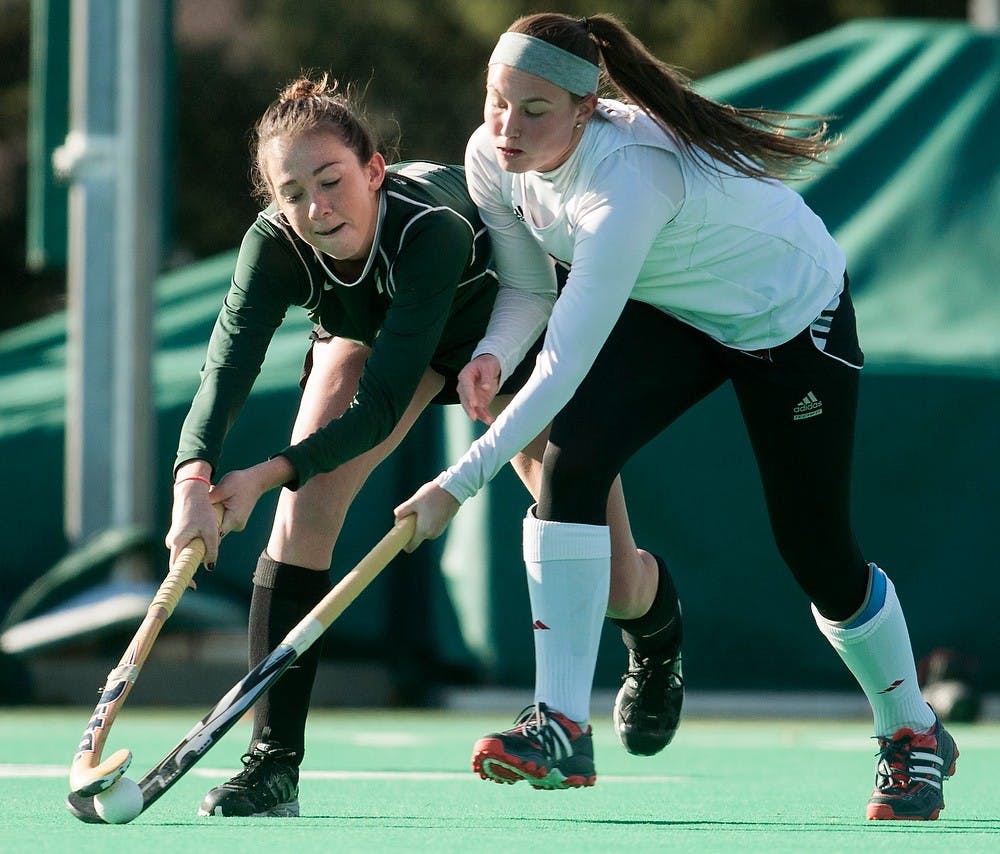 	<p>Junior midfielder Alli Helwig fights for possession of the ball with Miami (Ohio) midfield/back Jenna Kapsar on Nov. 13, 2013, at Ralph Young Field. The Spartans defeated the Redhawks, 3-0, during the first round of the <span class="caps">NCAA</span> tournament. Danyelle Morrow/The State News</p>