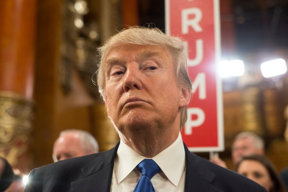 Businessman Donald Trump speaks to press in the spin room after the Republican Presidential Debate on March 3, 2016 at the Fox Theatre in Detroit.